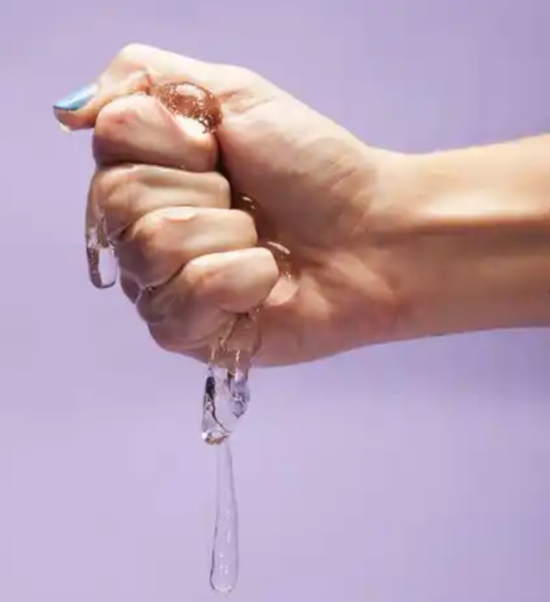 Hand holding lubrication liquid 