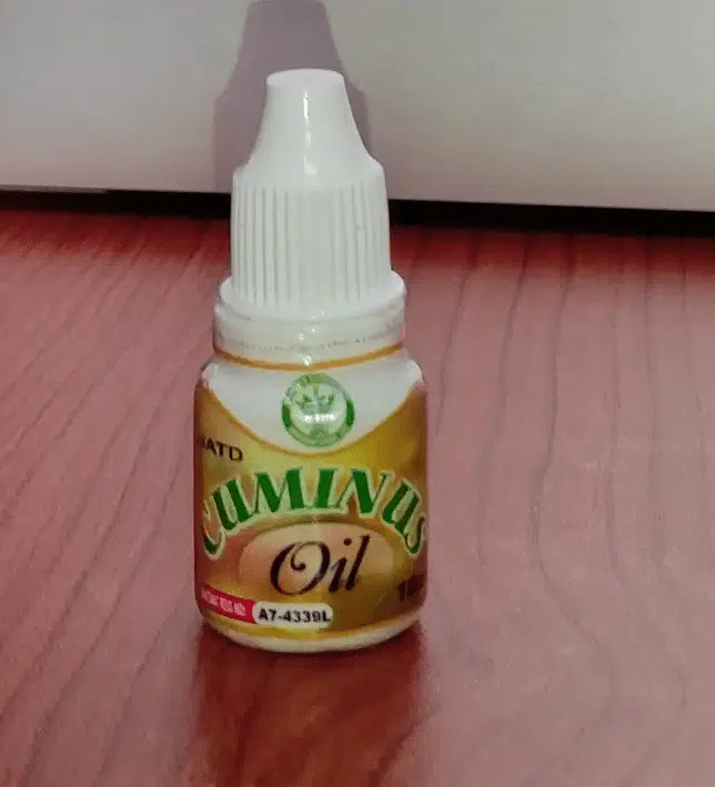 Cuminus oil on table